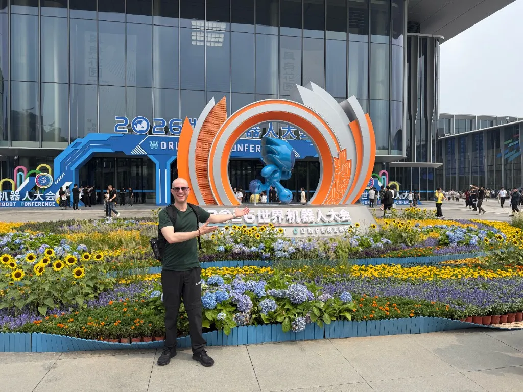 A güil team member outside the World Robot Conference venue in Beijing E-Town