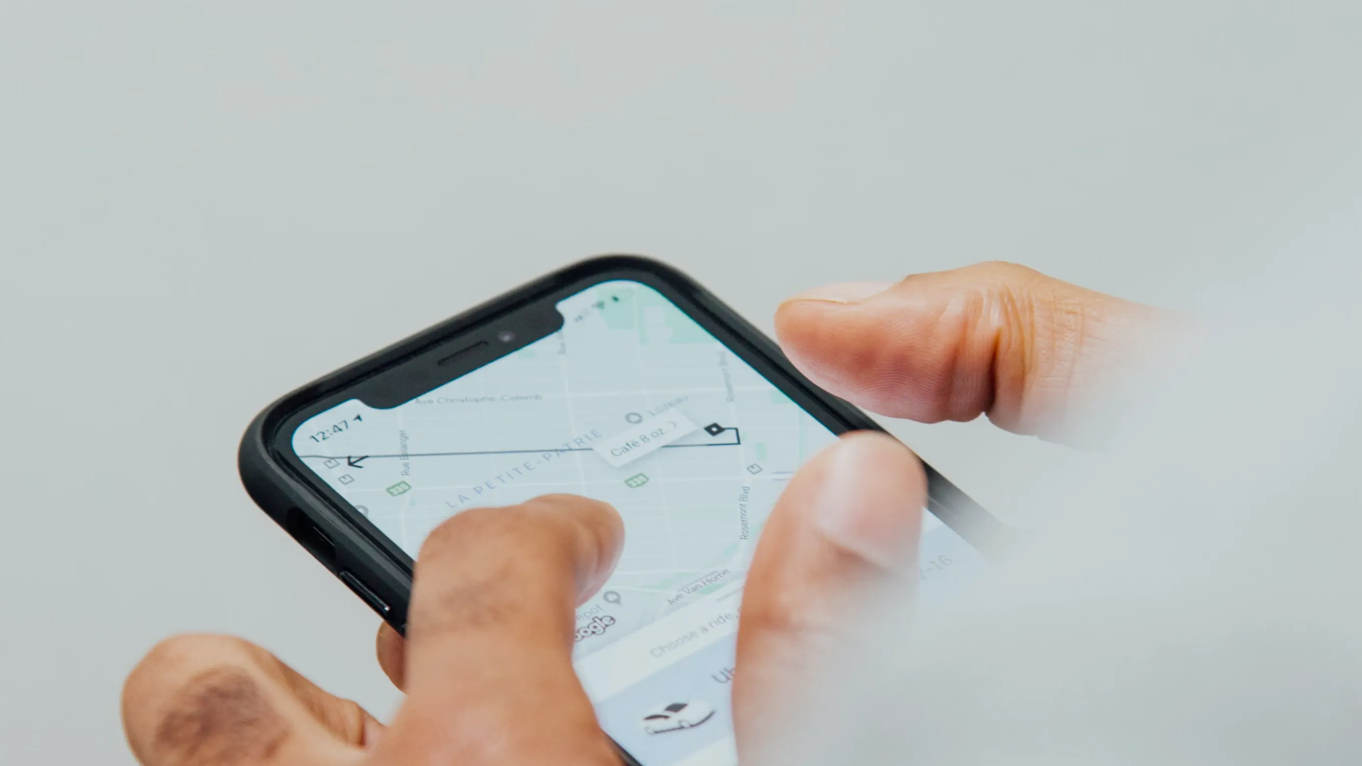 Hands using a smartphone with a map app