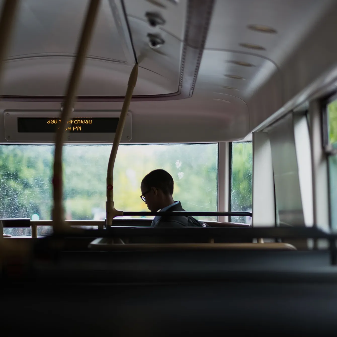 Person sitting on a bus looking out the window